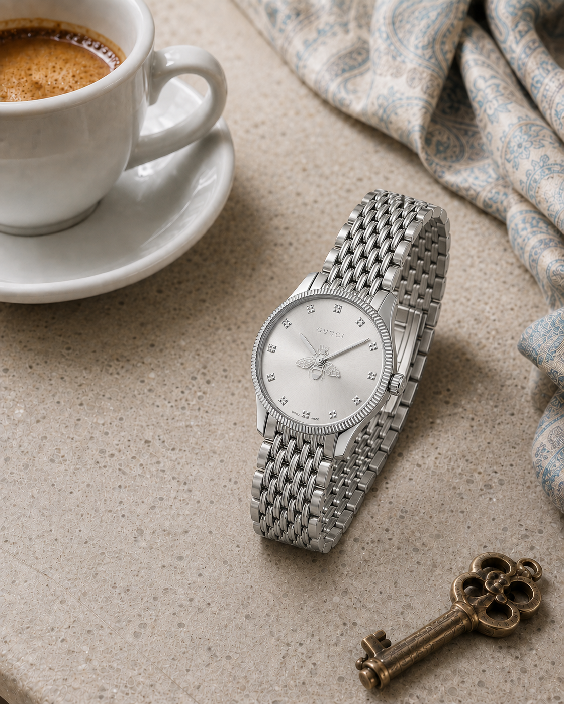 Gucci G-Timeless 29 mm Silver Bee Dial Watch YA1265019 styled in a cafe lifestyle setting