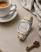 Gucci G-Timeless 32 mm Gold Bee Dial Watch YA1265032 styled in a cafe lifestyle setting