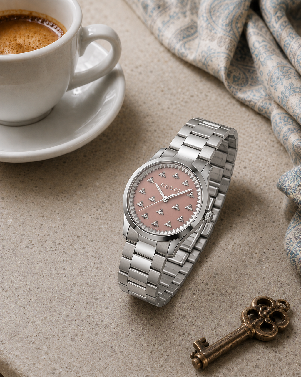 Gucci G-Timeless 32 mm Pink Bee Dial Watch YA1265033 styled in a cafe lifestyle setting