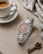 Gucci G-Timeless 32 mm Pink Bee Dial Watch YA1265033 styled in a cafe lifestyle setting