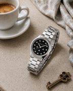 Gucci G-Timeless 32 mm Black Onyx Bee Dial Watch YA1265034 styled in a cafe lifestyle setting
