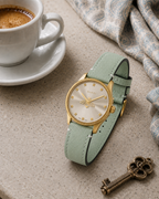 Gucci G-Timeless 29 mm Gold Bee Dial Watch YA1265040 styled in a cafe lifestyle setting