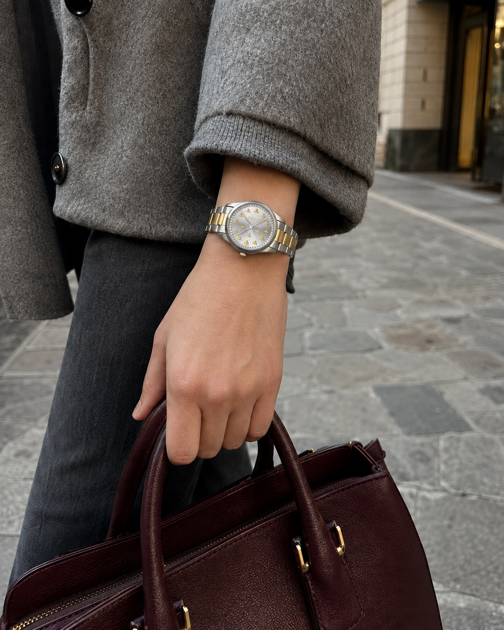 Gucci G-Timeless 32 mm Gold Bee Dial Watch YA1265032 styled in a city lifestyle setting
