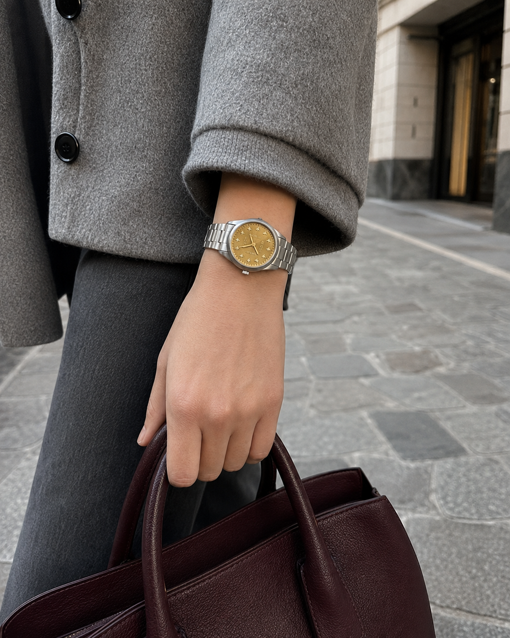 Gucci G-Timeless 32 mm Gold Bee Dial Watch YA1265035 styled in a city lifestyle setting