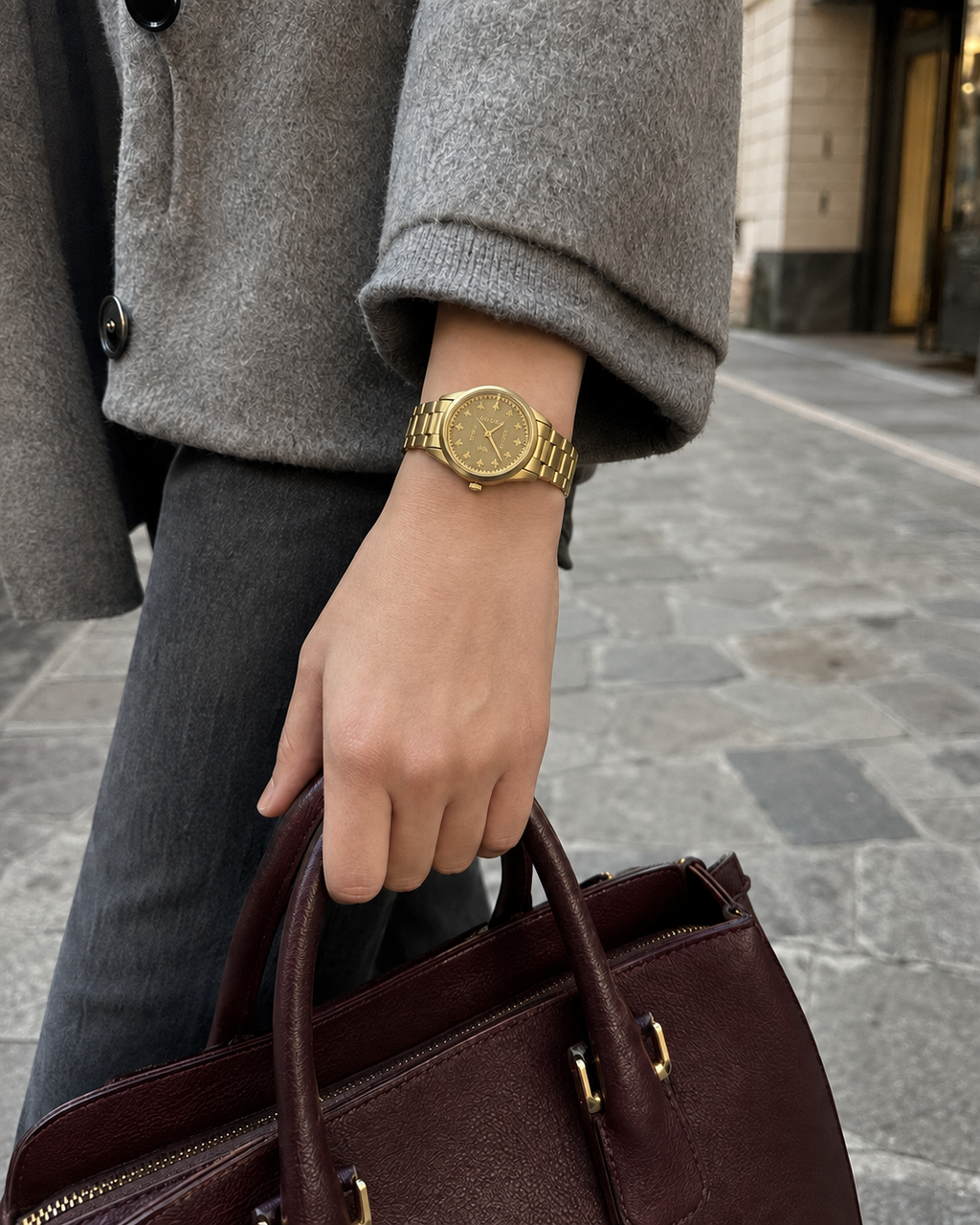 Gucci G-Timeless 32 mm Gold Bee Dial Watch YA1265036 styled in a city lifestyle setting