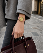 Gucci G-Timeless 29 mm Gold Bee Dial Watch YA1265041 styled in a city lifestyle setting
