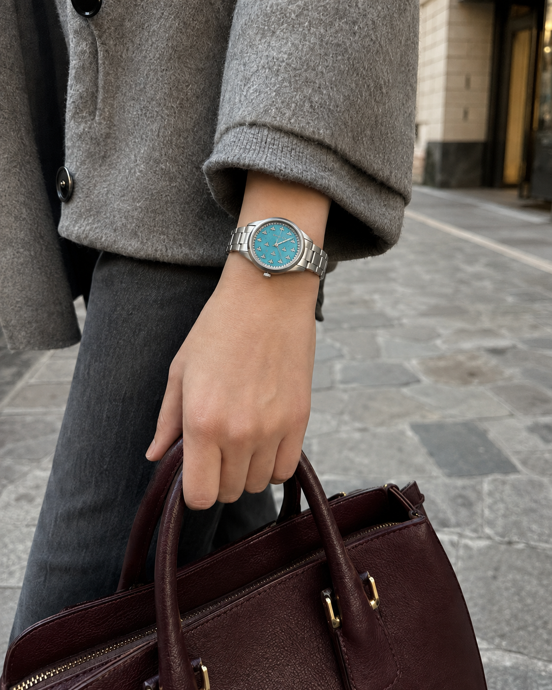 Gucci G-Timeless 32 mm Turquoise Bee Dial Watch YA1265044 styled in a city lifestyle setting