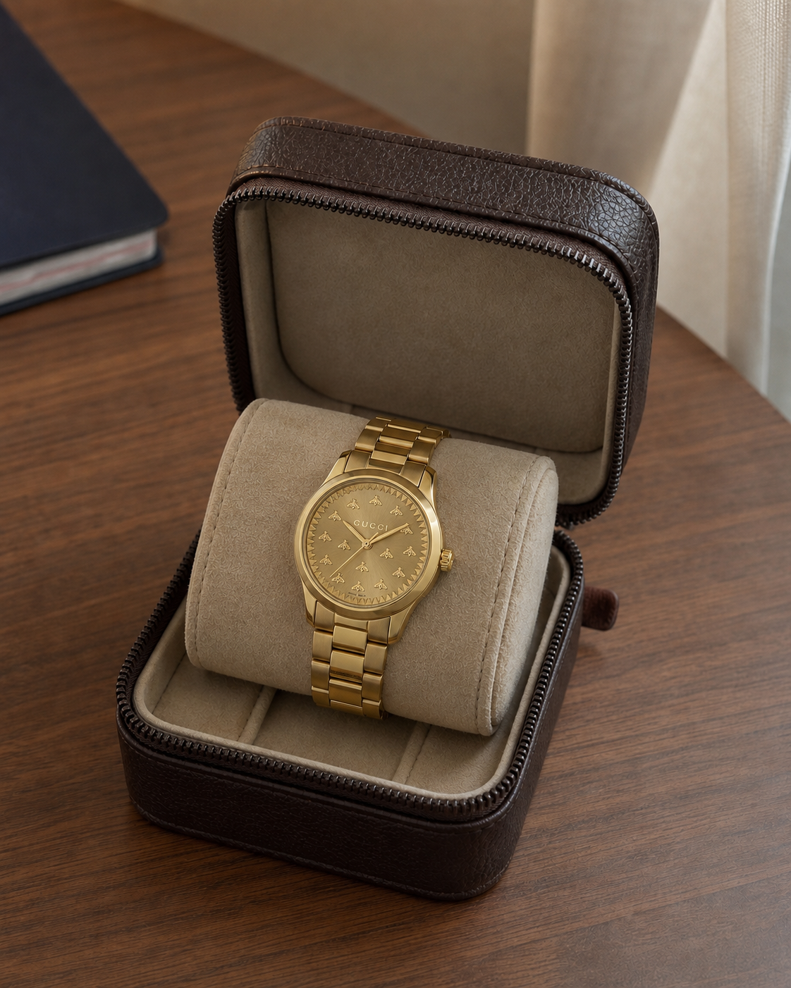 Gucci G-Timeless 32 mm Gold Bee Dial Watch YA1265036 presented in a luxury travel flat lay