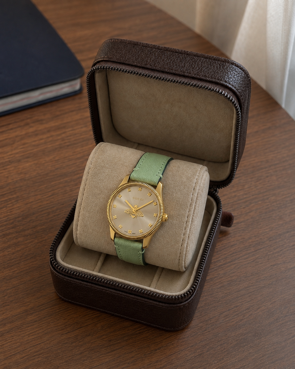 Gucci G-Timeless 29 mm Gold Bee Dial Watch YA1265040 presented in a luxury travel flat lay