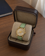 Gucci G-Timeless 29 mm Gold Bee Dial Watch YA1265040 presented in a luxury travel flat lay