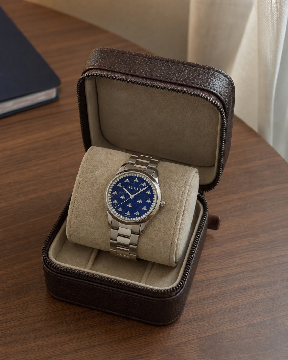 Gucci G-Timeless 32 mm Blue Lapis Bee Dial Watch YA1265043 presented in a luxury travel flat lay