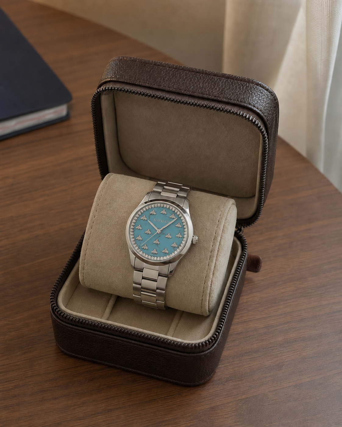 Gucci G-Timeless 32 mm Turquoise Bee Dial Watch YA1265044 presented in a luxury travel flat lay