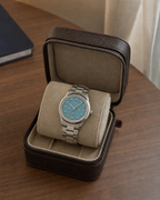 Gucci G-Timeless 32 mm Turquoise Bee Dial Watch YA1265044 presented in a luxury travel flat lay
