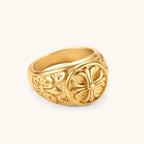 18K gold-plated stainless steel signet ring with ornate cross face and carved filigree scroll band, shown from three angles.