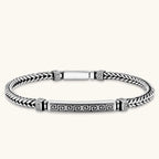 Silver stainless steel men's bracelet with braided foxtail chain, Greek key engraved bar, and decorative cube connectors.