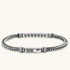 Silver stainless steel men's bracelet with braided foxtail chain, Greek key engraved bar, and decorative cube connectors.