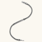Silver stainless steel men's bracelet with braided foxtail chain, Greek key engraved bar, and decorative cube connectors.