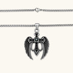 Silver stainless steel angel wing cross pendant necklace with green CZ center stone and black crystals on a box chain.