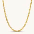 18K gold-plated twisted double herringbone snake chain necklace with lobster clasp and extender on white background.