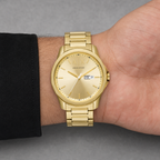 Armani Exchange AX1734 men's gold-tone day-date watch worn on inner wrist