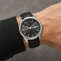 Armani Exchange AX1735 men's black dial day-date watch worn on inner wrist