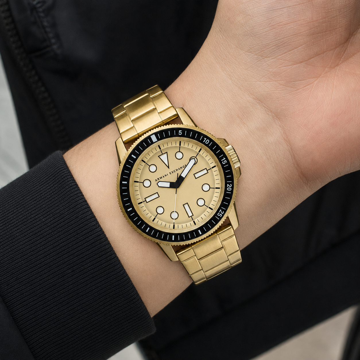 AX1854 men's gold-tone dive-style watch worn on the inner wrist