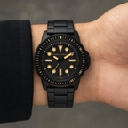 AX1855 men's black and gold dive-style watch worn on the inner wrist
