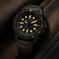 AX1855 men's black and gold dive-style watch editorial lifestyle view