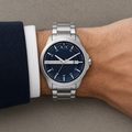 Armani Exchange AX2137 men's silver watch with navy dial on wrist