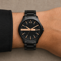 Armani Exchange AX2152 men's black and rose-gold-tone watch on wrist