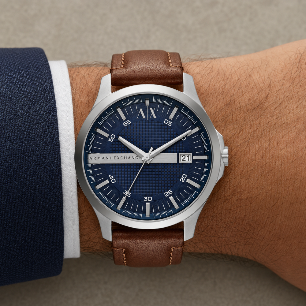 Armani Exchange AX2155 men's silver watch with navy dial and brown leather strap on wrist