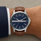 Armani Exchange AX2155 men's silver watch with navy dial and brown leather strap on wrist