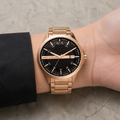 Armani Exchange AX2449 men's rose gold and black watch on inner wrist