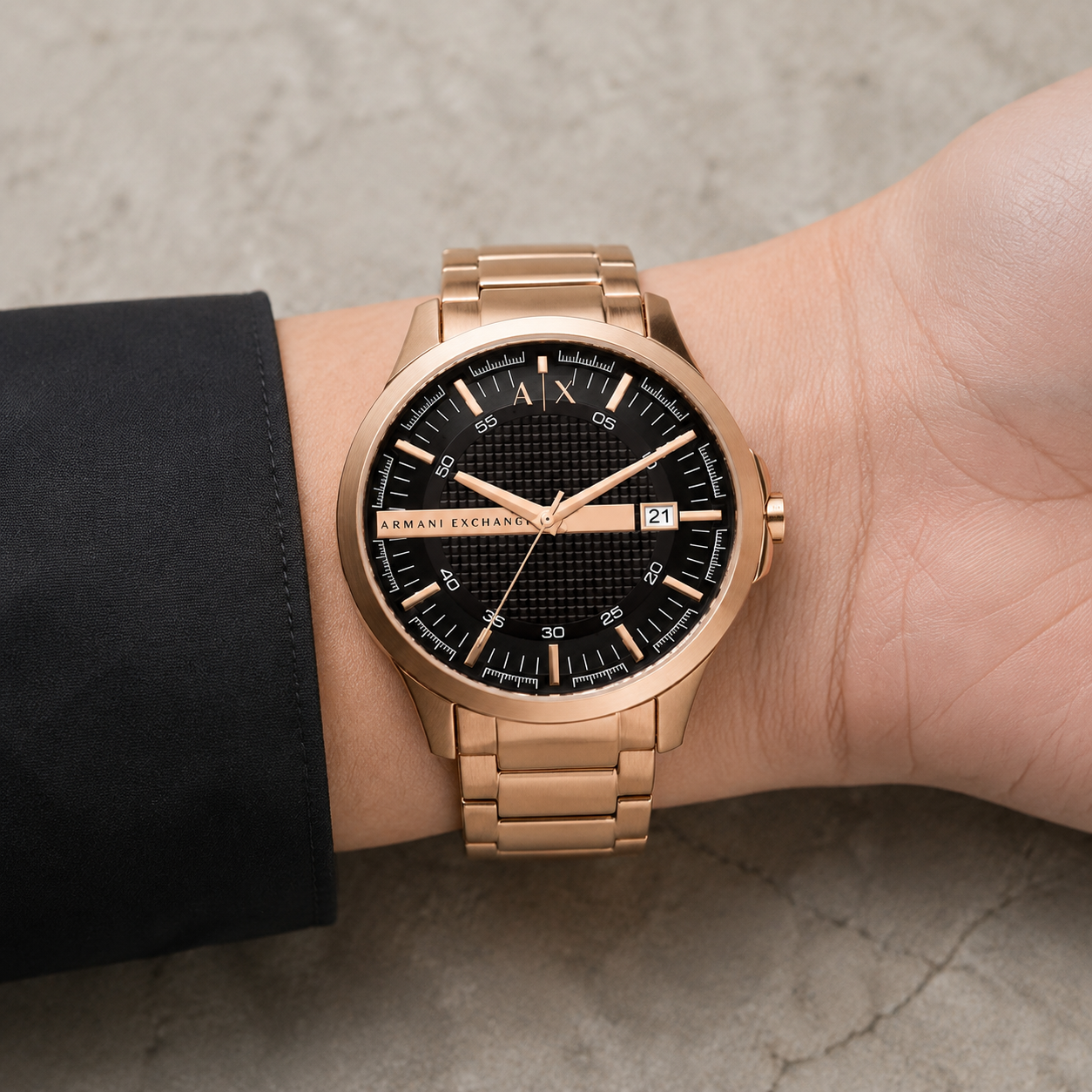 Armani Exchange AX2449 men's rose gold and black watch on inner wrist