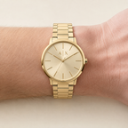 Armani Exchange AX2707 men's gold watch on inner wrist