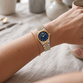 Michael Kors MK4865 gold-bezel blue-dial two-tone watch on a woman's wrist