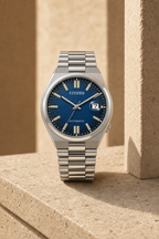 Citizen NJ0151-88L blue dial automatic watch in a warm limestone setting