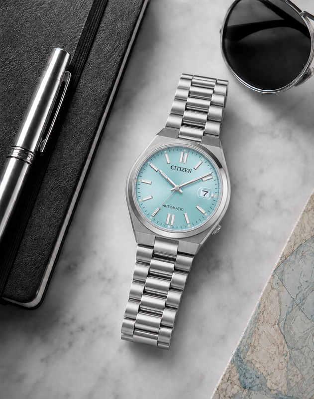 Citizen NJ0200-50L ice blue dial automatic watch in a premium marble flat-lay