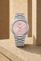 Citizen NJ0200-50Z pink dial automatic watch in a warm limestone setting