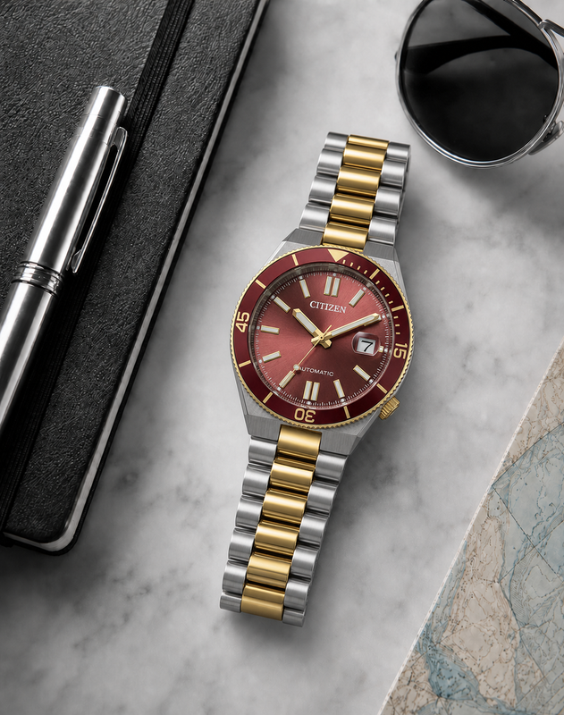 Citizen NJ0234-58X wine red dial automatic watch in a premium marble flat-lay