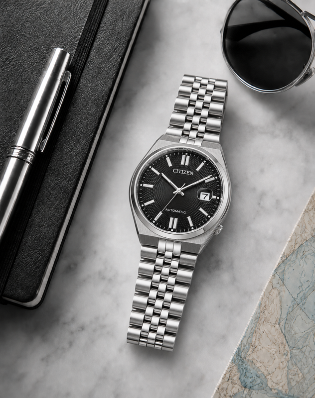 Citizen NK0020-55E black dial automatic watch in a premium marble flat-lay