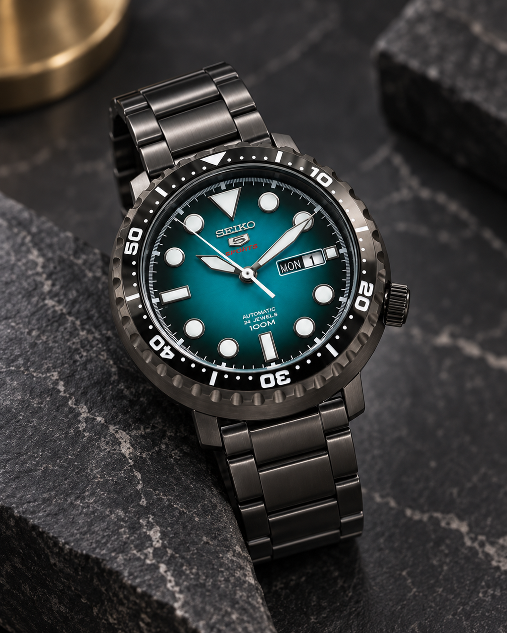 Seiko 5 Sports SRPC65J1 Bottle Cap automatic turquoise green dial watch on dark stone