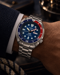 Seiko Prospex PADI Turtle SRPE99 automatic diver's watch on wrist, blue dial, red-blue bezel, stainless steel bracelet