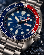Seiko Prospex PADI Turtle SRPE99 blue dial and red-blue bezel macro detail, automatic diver's watch