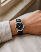 Gucci G-Timeless YA1265055 32 mm black onyx bee dial watch worn on a woman's wrist