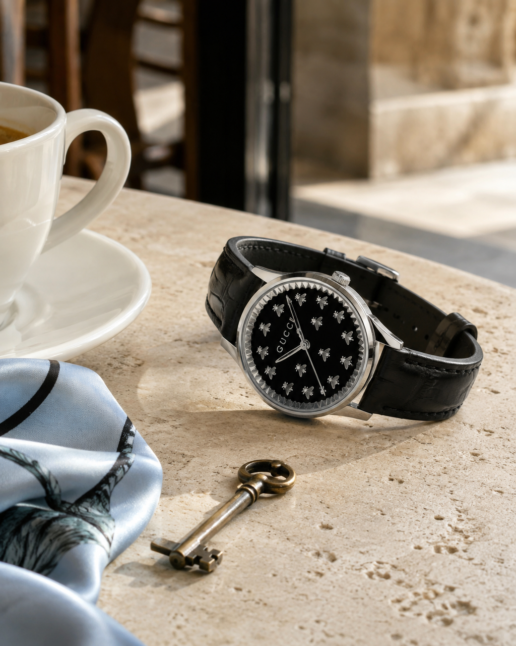 Gucci G-Timeless YA1265055 black onyx bee dial watch in an elegant cafe setting