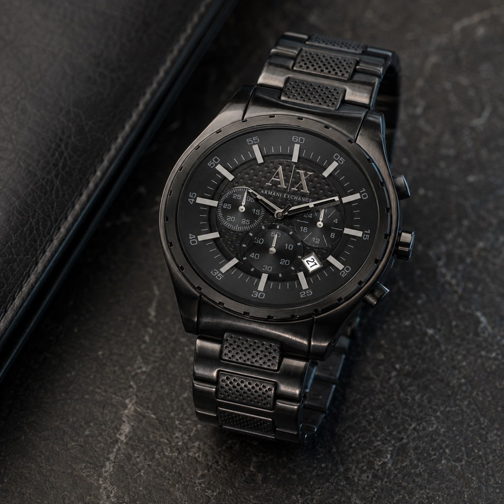 Armani Exchange AX1058 black chronograph watch on a dark desk