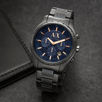 Armani Exchange AX1166 navy chronograph watch on a dark desk